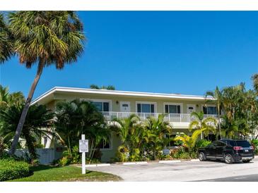 Two-story condo complex featuring well-maintained landscaping, mature trees, and assigned parking at 3000 Gulf Dr # 3, Holmes Beach, FL 34217