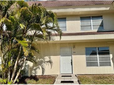 Inviting front entrance featuring well-maintained landscaping, offering a warm welcome to this charming home at 306 Barlow Ave # 77, Sarasota, FL 34232