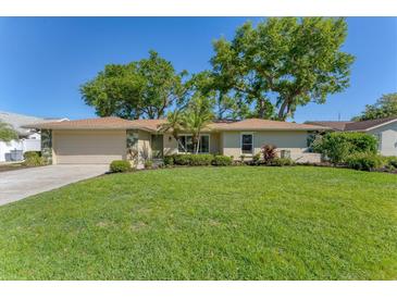 Charming single-story home with a lush lawn, mature trees, and well-maintained landscaping in a desirable neighborhood at 3979 Helene St, Sarasota, FL 34233