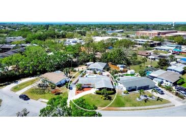 A lovely single-story home with a private pool, driveway, landscaped yard, and a white perimeter fence at 4008 Cape Vista Dr, Bradenton, FL 34209