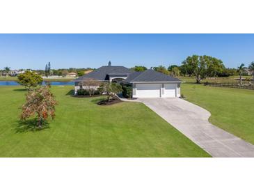 Well maintained ranch home with mature landscaping and a long driveway with a 3-car garage at 4606 Lake Fox Pl, Parrish, FL 34219