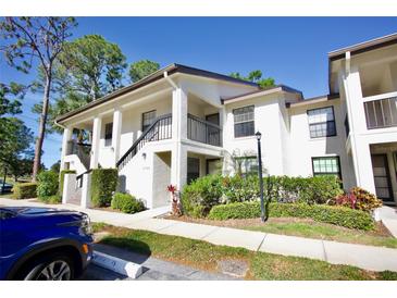 Well-maintained two-story condo featuring a balcony, lush landscaping, and parking at 4731 Winslow Beacon # 12, Sarasota, FL 34235