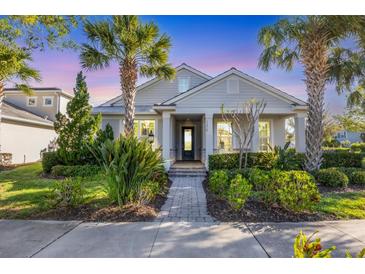 Charming single-story home featuring lush landscaping, a brick pathway, and a welcoming covered porch at 11717 Blue Hill Trl, Lakewood Ranch, FL 34211