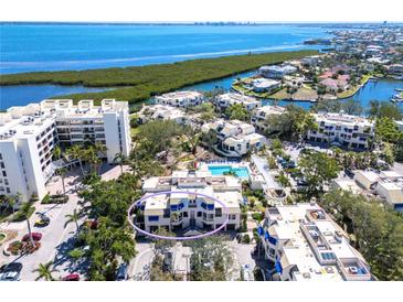 Aerial view showcases this waterfront condo community with a pool and stunning views of the bay at 1928 Harbourside Dr # 1403, Longboat Key, FL 34228