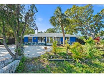 Charming blue single story home with lush landscaping and ample parking at 2728 Trinidad St, Sarasota, FL 34231