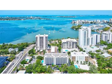 Stunning aerial view of waterfront condos with bay views and boat dotted harbor at 755 S Palm Avenue # 604, Sarasota, FL 34236