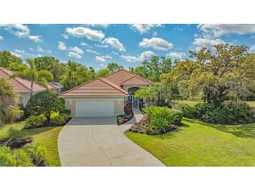 Well maintained property showing driveway, landscape, and roof at 7847 Chick Evans Pl, Sarasota, FL 34240