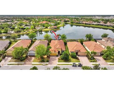 Beautiful single-Gathering home with terracotta roof tiles, surrounded by a lush green landscape and stunning water views at 12711 Del Corso Loop, Bradenton, FL 34211