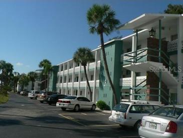Three-story apartment complex with palm trees and parking at 1838 Sunny Dr # D35, Bradenton, FL 34207