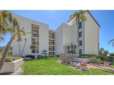 Beautiful condo building with manicured lawn and lush landscaping in a tropical setting at 1935 Gulf Of Mexico Dr # G7-402, Longboat Key, FL 34228
