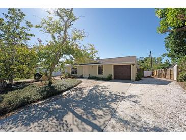 Charming single-story home featuring a well-kept lawn and a brown garage door at 2316 Bradford St, Sarasota, FL 34231