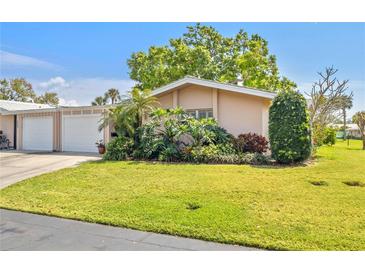 Charming single-story home featuring mature landscaping and an attached two-car garage at 3328 Dartmouth Ln # 1012, Sarasota, FL 34239