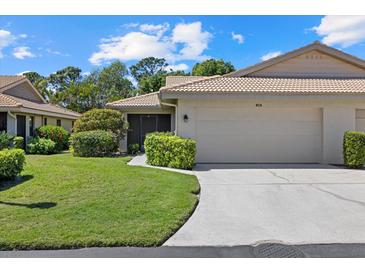 Charming home with manicured lawn, tile roof, and an attached two-car garage at 7205 Wood Creek Dr # 16, Sarasota, FL 34231