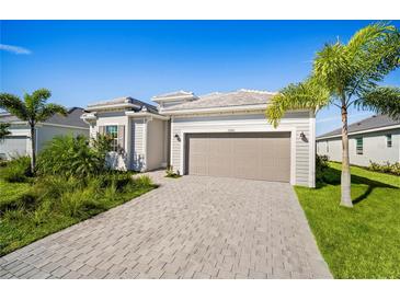 Charming single-story home featuring a paved driveway, attached two-car garage, and professionally landscaped front yard at 15916 Sugar Hill Dr, Punta Gorda, FL 33982
