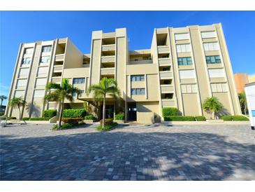 Beautiful condominium building with palm trees and brick-paved parking at 2675 Gulf Of Mexico Dr # 403, Longboat Key, FL 34228