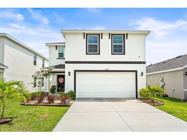 Charming two-story home featuring a clean white exterior and well-manicured lawn, plus a two car garage at 3027 Great Abaco Way, Bradenton, FL 34208
