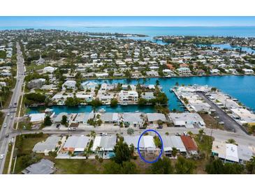 A beautiful aerial view of a waterfront property in a coastal community with nearby access to open water at 415 63Rd St, Holmes Beach, FL 34217