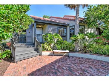 Charming home featuring a brick entry, gray wood siding, and mature landscaping for added privacy at 4375 Trails Dr # 17-1, Sarasota, FL 34232