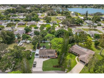 An aerial view of a home with mature landscaping, a lengthy drive and nearby views of the lake at 4619 20Th W Ave, Bradenton, FL 34209