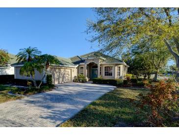 Charming single story home featuring a paved driveway, two-car garage and lush landscaping at 6619 Copper Ridge Trl, Bradenton, FL 34201