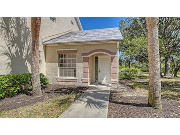 Charming front entrance with a pathway, window, and neatly landscaped surroundings at 7687 Sweetbay Cir # 7687, Bradenton, FL 34203