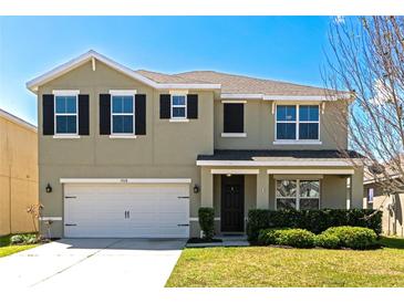 Charming two-story home with a well-maintained lawn and a two-car garage at 15118 Agave Grove Pl, Bradenton, FL 34212