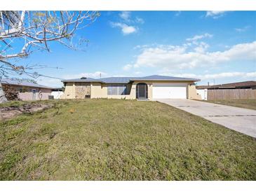 Nice home with a two-car garage and a lovely yard at 19990 Midway Blvd, Port Charlotte, FL 33948