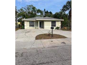 Charming single-story home with a spacious driveway and tropical landscaping at 2510 N Osprey Ave, Sarasota, FL 34234
