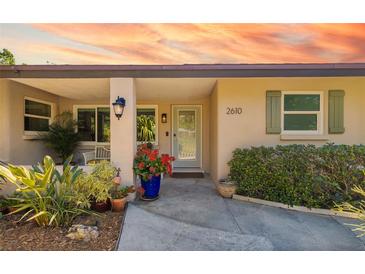 Inviting front entrance with decorative plants, stylish sconces, and light green trim at 2610 Jefferson Cir, Sarasota, FL 34239