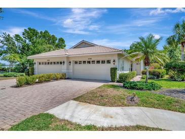 Charming single Gathering home featuring a two-car garage, well manicured yard, and a tile roof at 4344 Nizza Ct, Venice, FL 34293