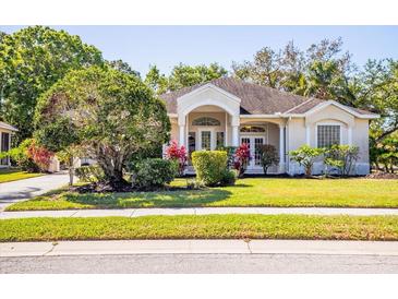 Charming single-story home featuring a well-manicured front yard with lush landscaping and an inviting entrance at 6602 Peach Tree Creek Rd, Bradenton, FL 34203