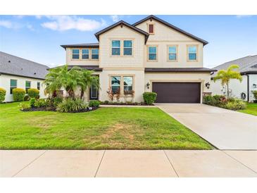 Charming two-story home with landscaped yard and attached two car garage at 750 116Th Ne Ct, Bradenton, FL 34212