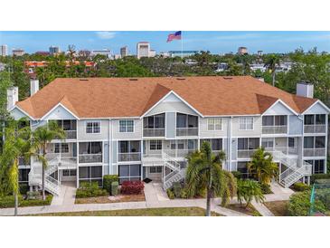 Multi-Gathering building with beautiful landscaping, open balconies, and stairs, plus city views and palm trees at 850 S Tamiami Trl # 207, Sarasota, FL 34236