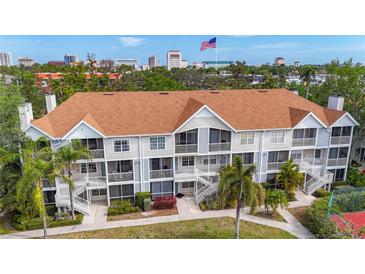 Charming condo building featuring screened balconies and lush landscaping in a well-maintained community at 850 S Tamiami Trl # 730, Sarasota, FL 34236