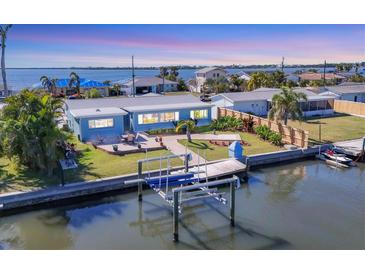 Charming waterfront home with private boat lift and dock provides Gulf access and stunning water views at 4908 Arlington Rd, Palmetto, FL 34221
