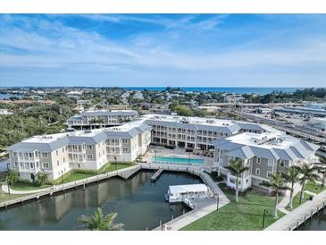 Beautiful aerial view of the resort-style condo complex with water access, a pool, and stunning views at 5325 Marina Drive # 423, Holmes Beach, FL 34217