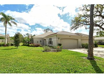 Lovely single-story home with a well-manicured lawn, lush landscaping, and a two-car garage at 3950 Oakley Greene # 36, Sarasota, FL 34235