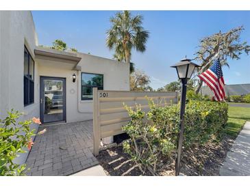 Inviting front entrance with brick paved patio, well maintained landscaping and clear numbering to locate the property at 501 Lakeside Dr # 501, Bradenton, FL 34210