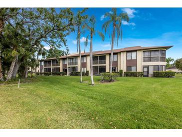 Well-maintained condo building with green lawns, mature trees and screened lanais offering comfortable outdoor living at 5729 Avista Dr, Sarasota, FL 34243
