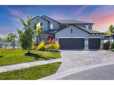 Beautiful two-story home with well-manicured lawn and a three-car garage at 5833 Millennium Silver Ct, Sarasota, FL 34238