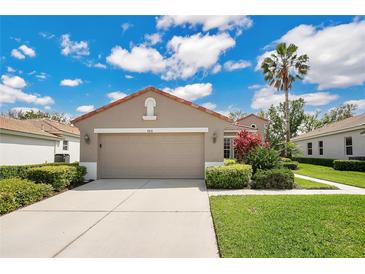 Charming single-story home with a well-manicured lawn, two car garage, and beautiful landscaping at 9818 Portside Ter, Bradenton, FL 34212