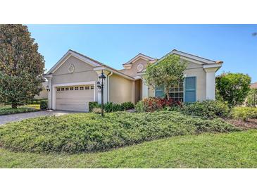 Charming one-story home features a well-manicured lawn, two-car garage, and lovely landscaping at 14404 Stirling Dr, Lakewood Ranch, FL 34202