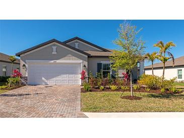 Charming single-story home with a brick driveway, two-car garage, and well-manicured landscaping at 5307 Senza Trl, Palmetto, FL 34221
