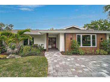 Exterior front facade features mid-century modern architecture with landscaped grounds at 577 Corwood Dr, Sarasota, FL 34234