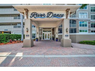Inviting entrance to River Dance with covered portico and well-maintained landscaping at 808 3Rd W Ave # 214, Bradenton, FL 34205