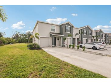 Charming townhome with well-manicured lawn, driveway and attached garage for easy access at 8600 Milestone Dr, Sarasota, FL 34238