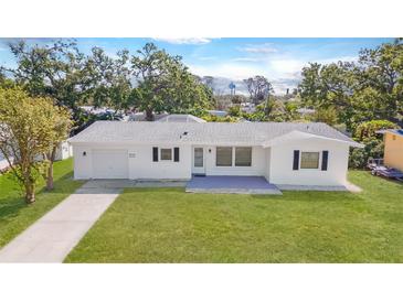 Charming single-story home featuring a well-manicured lawn and a freshly painted white exterior at 923 Dawn St, Venice, FL 34285