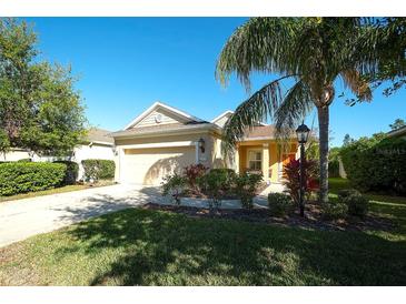 Charming one-story home with well-maintained landscaping, a two-car garage and a beautiful palm tree at 11836 Crawford Parrish Ln, Parrish, FL 34219