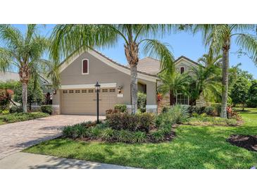 Charming single-story home with well-manicured lawn and lush tropical landscaping at 12041 Thornhill Ct, Lakewood Ranch, FL 34202