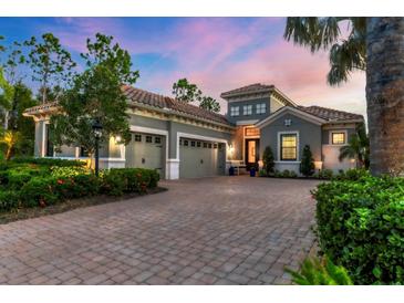 Stunning two-story home with a three car garage, beautiful landscaping, and a brick driveway at 15024 Castle Park Ter, Lakewood Ranch, FL 34202